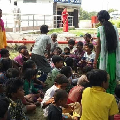 Shubhkarman volunteers with children and families at a distribution drive
