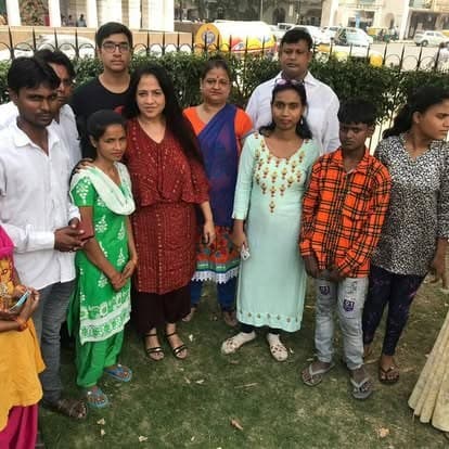 Shubhkarman volunteers with children and families at a distribution drive