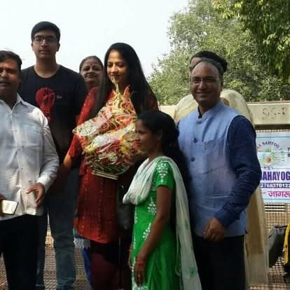 Shubhkarman volunteers with children and families at a distribution drive