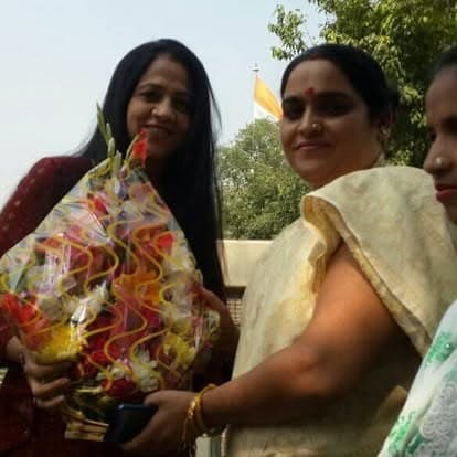 Shubhkarman volunteers with children and families at a distribution drive