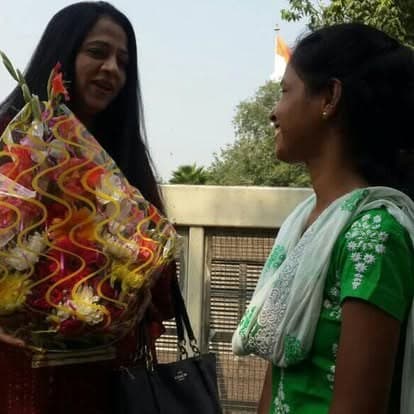 Shubhkarman volunteers with children and families at a distribution drive