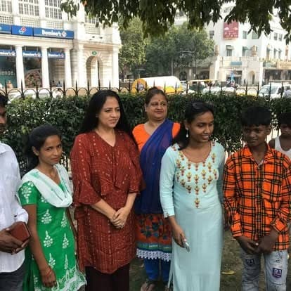 Shubhkarman volunteers with children and families at a distribution drive