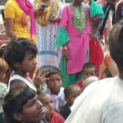 Shubhkarman volunteers with children and families at a distribution drive